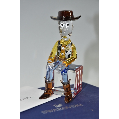 813 - A BOXED SWAROVSKI CRYSTAL TOY STORY 'SHERIFF WOODY' FIGURE, model no 5417631, the character from the... 