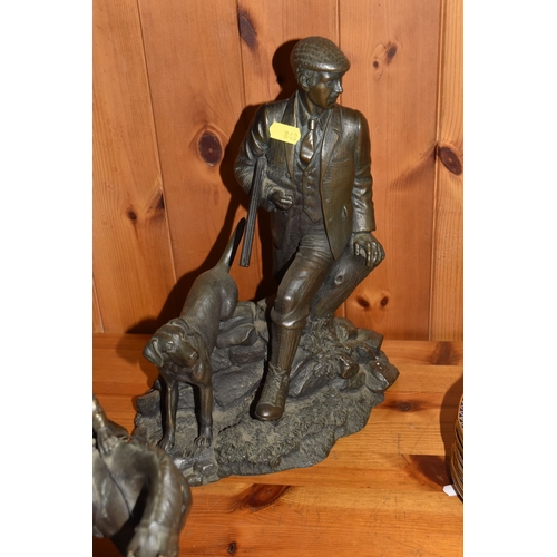 848 - A GROUP OF THREE BRONZED FIGURINES to include a bronzed resin hunter and his gun dog approximately 3... 