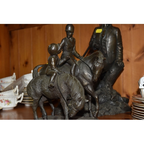 848 - A GROUP OF THREE BRONZED FIGURINES to include a bronzed resin hunter and his gun dog approximately 3... 