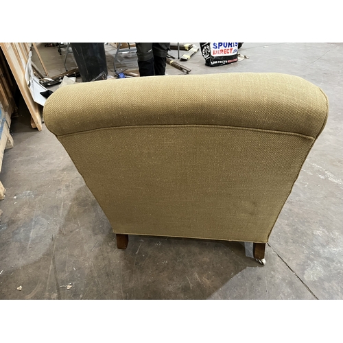 29 - A HOWARD AND SONS STYLE ARMCHAIR, on square turned legs, and chrome casters, width 80cm x depth 104c... 