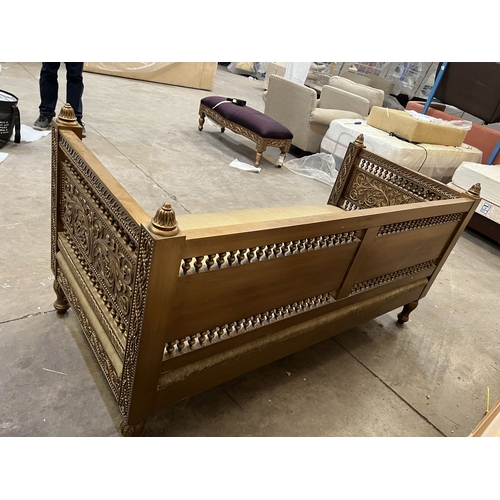 3 - A LATE 20TH CENTURY INDIAN STYLE GILTWOOD DAY BED, carved with foliage decoration throughout, and tu... 