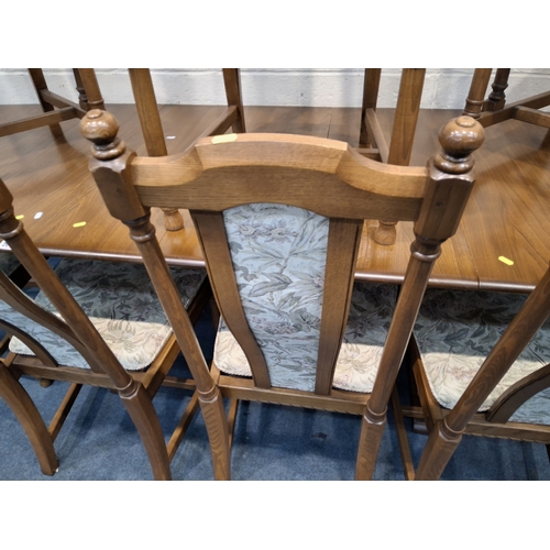 201 - LUCIAN ERCOLANI, AN ERCOL ELM AND BEECH EXTENDING DINING TABLE, with three additional leaves, raised... 