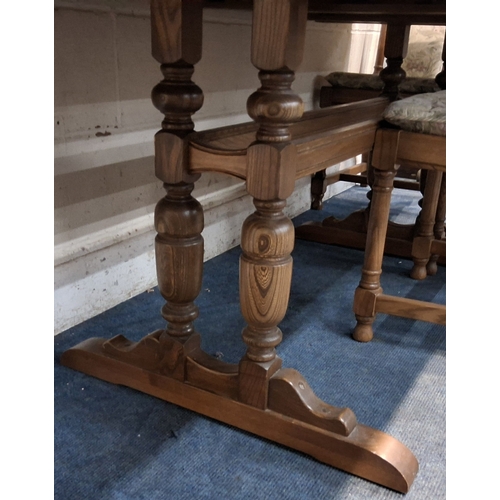 201 - LUCIAN ERCOLANI, AN ERCOL ELM AND BEECH EXTENDING DINING TABLE, with three additional leaves, raised... 