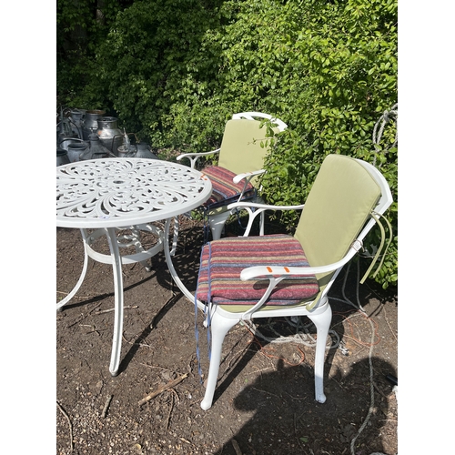 4 - A CAST ALUMINIUM GARDEN TABLE WITH TWO SIMILAR CHAIRS, all have pierced fretwork detail, table, diam... 