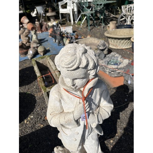 17 - A CONCRETE GARDEN FIGURE, in the form of a boy leaning against a tree stump, 78cm tall