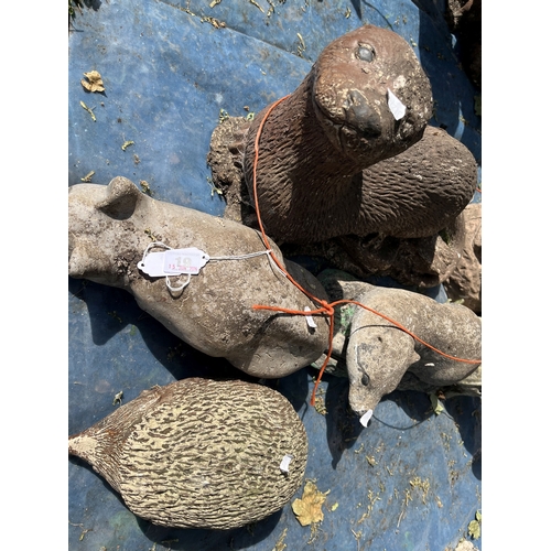 19 - A COLLECTION OF CONCRETE GARDEN FIGURES including otters, squirrels, dog, cats, a badger, etc (7)