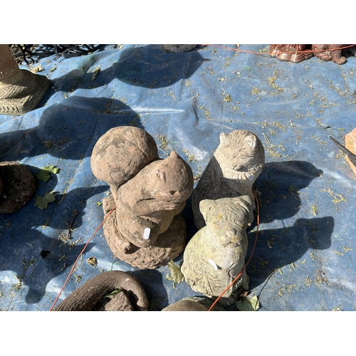 19 - A COLLECTION OF CONCRETE GARDEN FIGURES including otters, squirrels, dog, cats, a badger, etc (7)