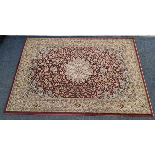 A RED AND CREAM GROUND RECTANGULAR RUG, with repeating foliate patterns ...