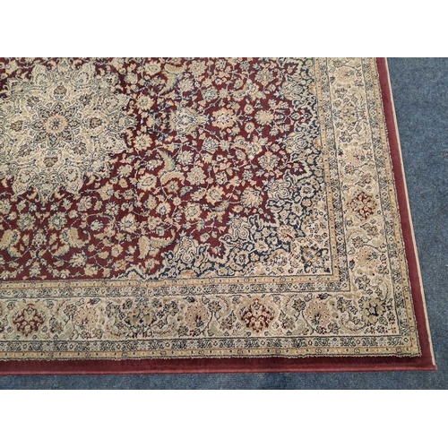 A RED AND CREAM GROUND RECTANGULAR RUG, with repeating foliate patterns ...