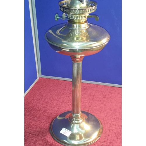 149 - Brass paraffin lamp with glass shade, 70cm tall