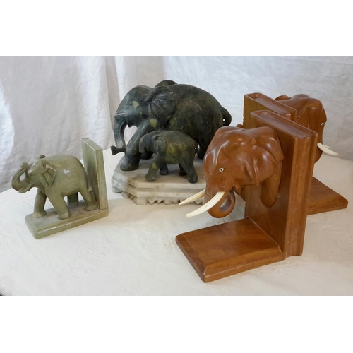 132 - A pair of large jade elephant figurines on white hard stone base, together with hard stone elephant ... 