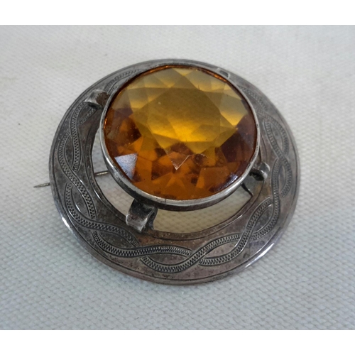 57 - Silver plaid brooch with large citrine stone. 4.5cm diameter