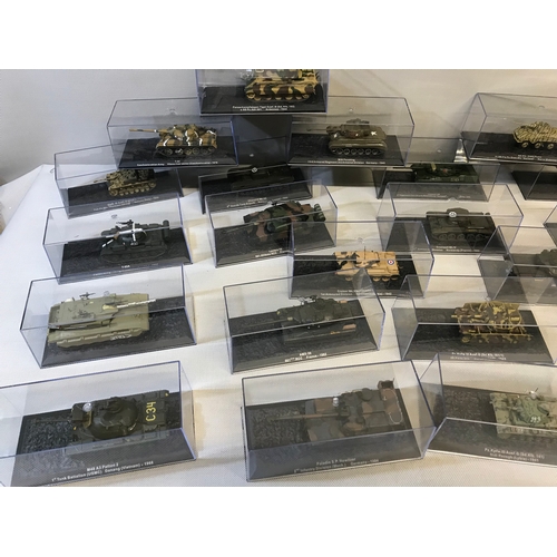 468 - Collection of 24 die cast model tanks all with protective casings