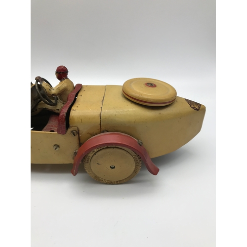 25 - A 1930's Meccano racing car construction set. Made from tin plate. Cream body with red trims and rac... 