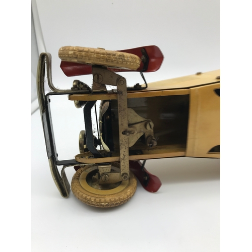25 - A 1930's Meccano racing car construction set. Made from tin plate. Cream body with red trims and rac... 