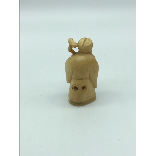 26 - An antique hand carved ivory netsuke of an old man with cane. Signed by the artist. possibly meiji p... 