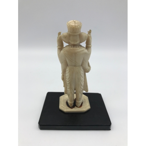 27 - An early 1900s hand carved ivory Ganesha god figure with a hardwood stand. Measures 10.5cm in height... 