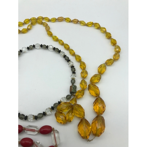 28 - A Lot of 3 vintage 1910/ 20's glass and bead necklaces. Includes Amber graduating glass bead necklac... 