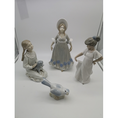 72 - Two Nao girl figurines, a Q'Art.SA lady figurine & a bird figurine completed in a Nao manner