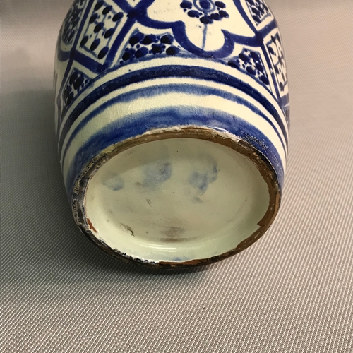 105 - A Persian antique blue and white painted vase. Measures 18cm in height.