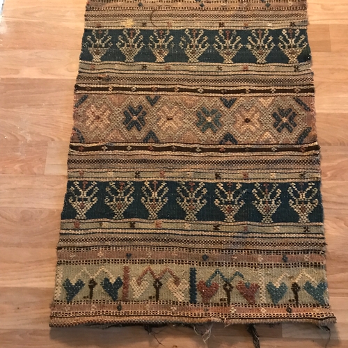 208 - An antique hand woven rug, Done in the style of a sampler. Measures 96x63cm