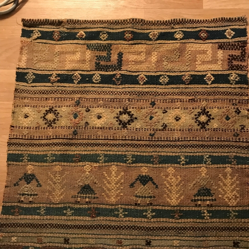 208 - An antique hand woven rug, Done in the style of a sampler. Measures 96x63cm