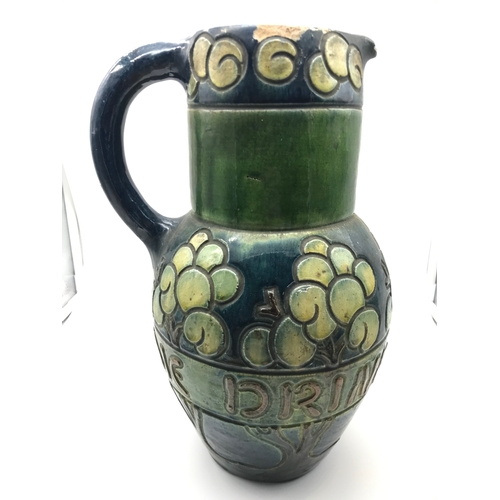 220 - Antique Glazed pottery water jug possibly Scottish. Designed with trees and worded round the middle ... 