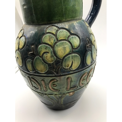 220 - Antique Glazed pottery water jug possibly Scottish. Designed with trees and worded round the middle ... 