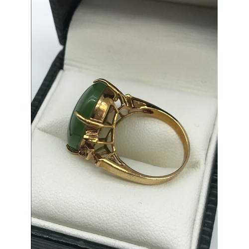 16 - An antique gold ring set with a large oval shaped jade stone, Ring size J, Weighs 3.60 grams, Stone ... 