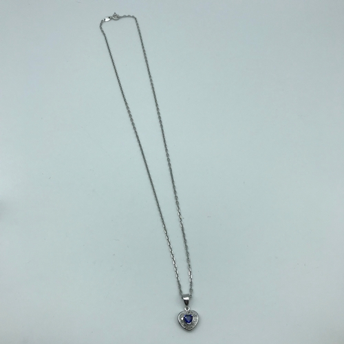 22 - An 18ct white gold necklace with a 18ct white gold diamond and sapphire heart shaped pendant, Weighs... 