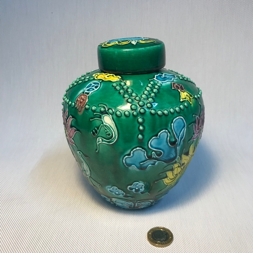 111 - A Chinese enamel painted preserve pot, depicting raised designed flowers, beads and birds. Has a Kan... 