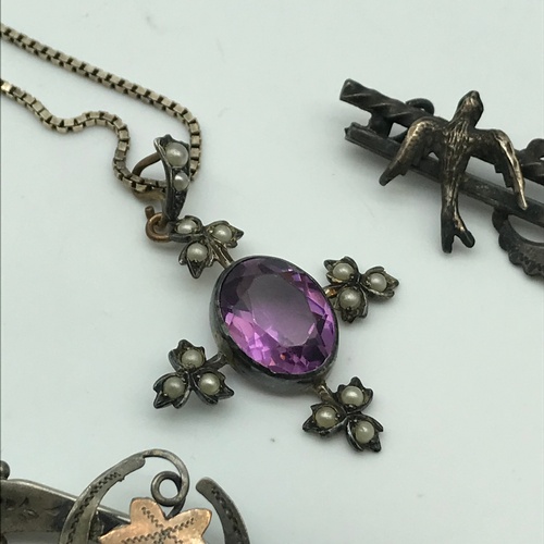 85J - Art Nouveau silver pendant fitted with seed pearls and centred with a large purple glass stone, silv... 