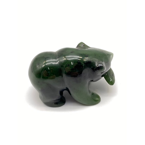 7 - A Oriental Hand carved Jade bear holding a fish within its mouth sculpture. Measures 4x6.5x4cm