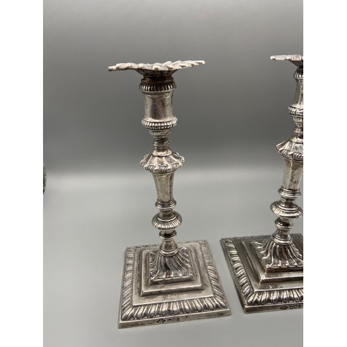 157J - A Pair of ornate London silver candle sticks made by Johnson Walker & Tolhurst. Dated 1909. [16cm he... 