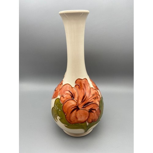 3A - A Vintage Moorcroft vase detailing a tubelined Hibiscus flower design. Impressed to the base and Sig... 