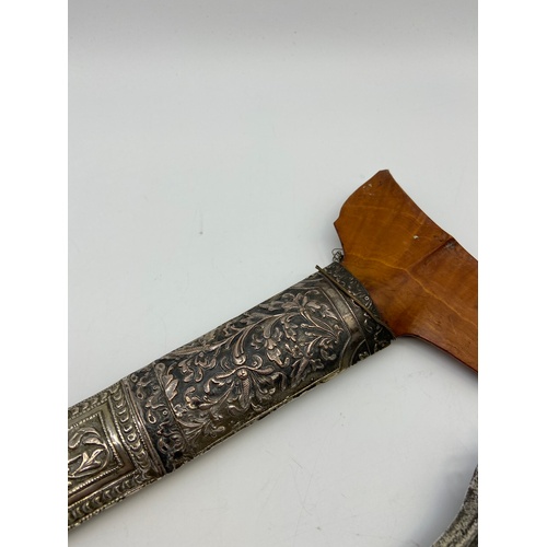 5A - A 19th century Kris or Keris dagger with silver ornate sheath. Handle is made of wood and silver mou... 