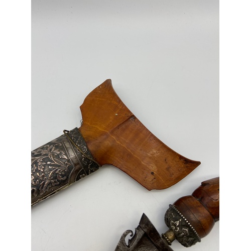 5A - A 19th century Kris or Keris dagger with silver ornate sheath. Handle is made of wood and silver mou... 