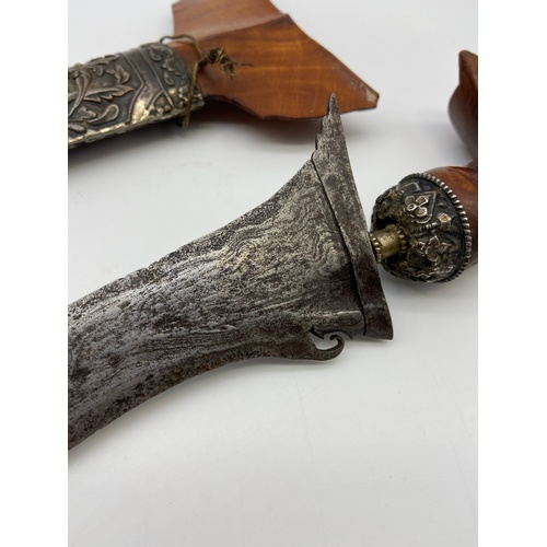 5A - A 19th century Kris or Keris dagger with silver ornate sheath. Handle is made of wood and silver mou... 