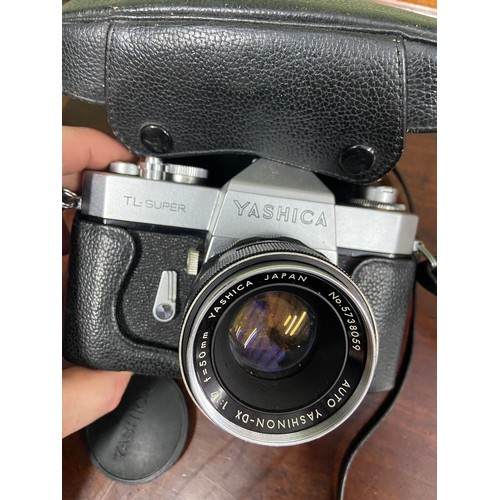 72A - A Vintage Yashica  TL-Super camera with fitted lens together with a large Soligor zoom lens with car... 