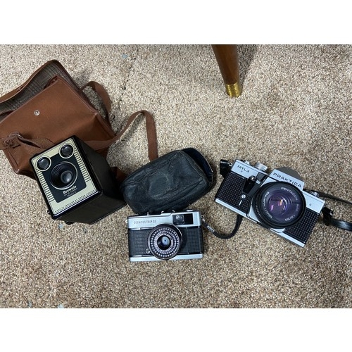 78A - Three vintage cameras which include Kodak Brownie model c, Olympus Trip 35 & Praktica MTL3.