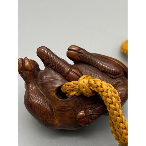 160J - A Meiji period hand carved Japanese netsuke of an Ox laying down, Design with black bead eyes, signe... 