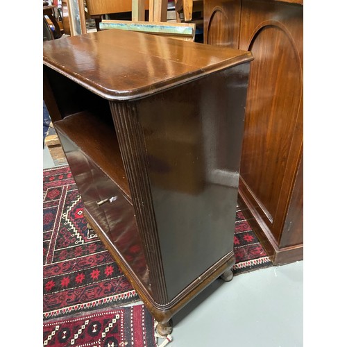 122A - A 20th century mahogany console unit. Designed with a shelving area, two doors which revealing a sto... 