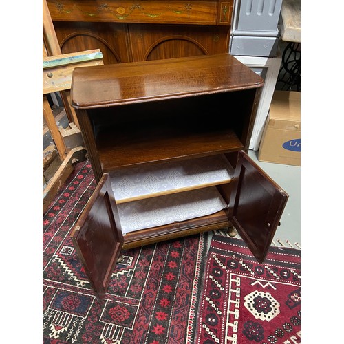 122A - A 20th century mahogany console unit. Designed with a shelving area, two doors which revealing a sto... 