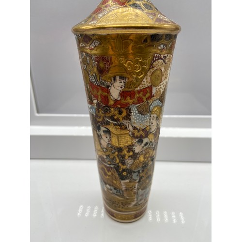 135 - A Japanese Satsuma hand painted vase. Designed with various figures and gilt trims. Signed to the ba... 