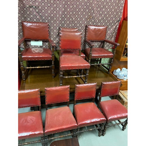 107B - A Large antique dining table with pull out leaves. Together with 6 antique red leather and stud fini... 