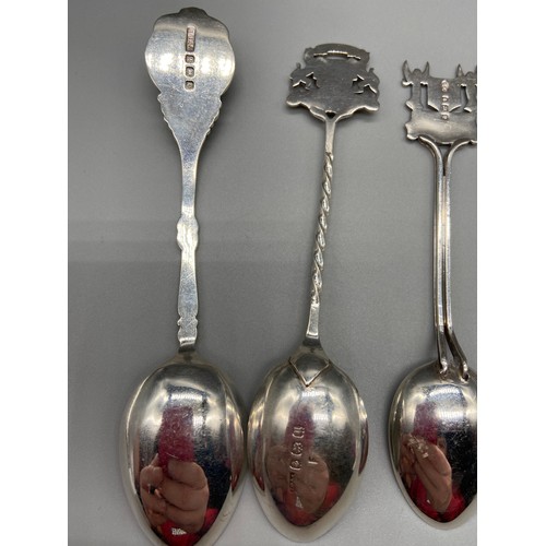 25 - A Lot of seven Birmingham Silver souvenir tea spoons. Some designed with enamel tops.