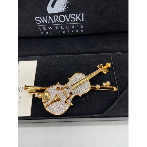 43J - A Lovely example of a Swarovski brooch in the shape of a violin and bow. Comes with a box.