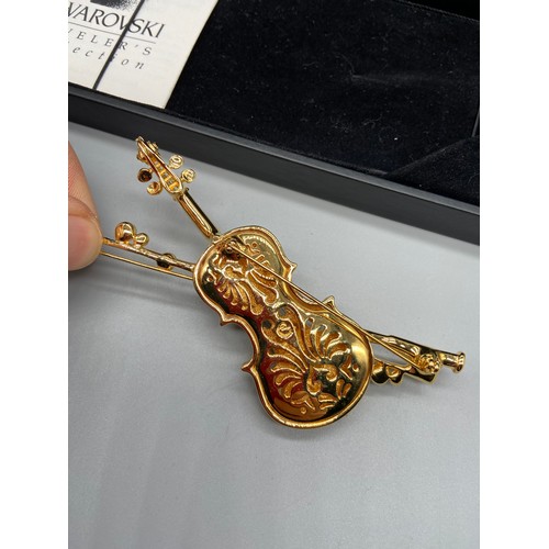 43J - A Lovely example of a Swarovski brooch in the shape of a violin and bow. Comes with a box.