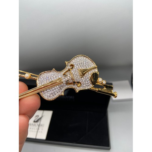 43J - A Lovely example of a Swarovski brooch in the shape of a violin and bow. Comes with a box.