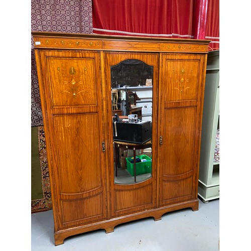 209 - A Late Victorian/Early Edwardian triple wardrobe, Designed with various inlaid panels and trims. Cen... 